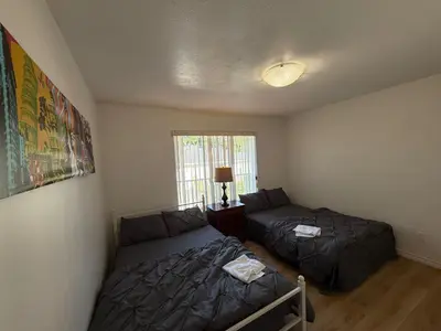 a small bedroom with two beds and a window at Cozy Private Room near Langara College Skytrain Station in Vancouver