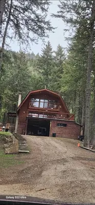 a large wooden house in the middle of a forest at Brown Family Farm in Grand Forks