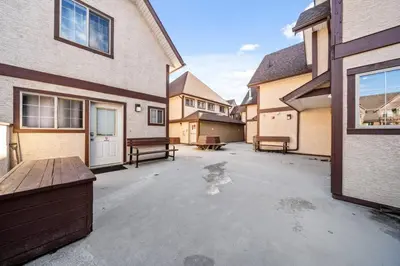 an empty parking lot in front of a house at Traveler Friendly Canmore Condo Close to Banff in Canmore