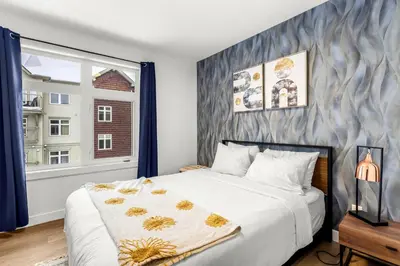 a bedroom with a large bed and a window at Mesmerizing 2BR Retreat Made For You in Canmore