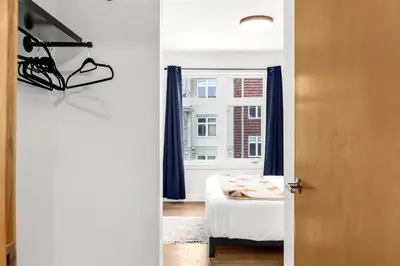a door to a room with a bed and a window at Mesmerizing 2BR Retreat Made For You in Canmore