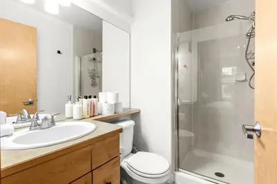 a bathroom with a toilet and a sink and a shower at Mesmerizing 2BR Retreat Made For You in Canmore