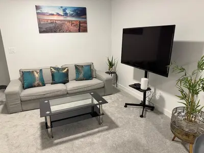 a living room with a couch and a flat screen tv at Peace Haven in Edmonton