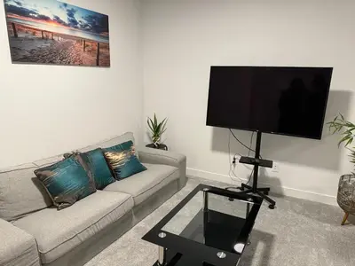 a living room with a couch and a flat screen tv at Peace Haven in Edmonton