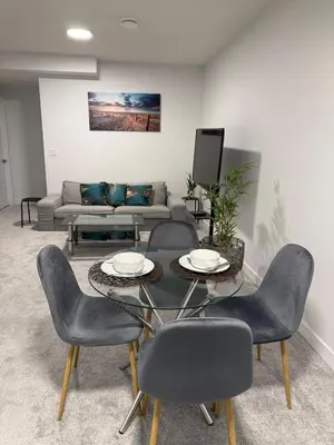 a living room with a table and chairs and a couch at Peace Haven in Edmonton