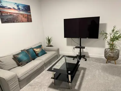a living room with a couch and a flat screen tv at Peace Haven in Edmonton