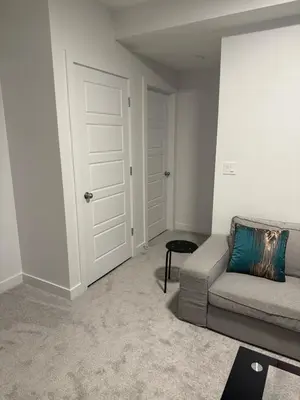a living room with a couch and a door at Peace Haven in Edmonton