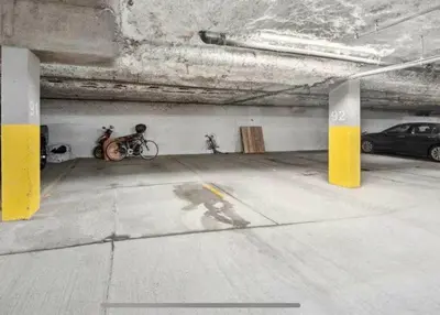 a parking garage with two bikes parked in it at Peaceful DT Condo, Saddledome, HeatedParking in Calgary