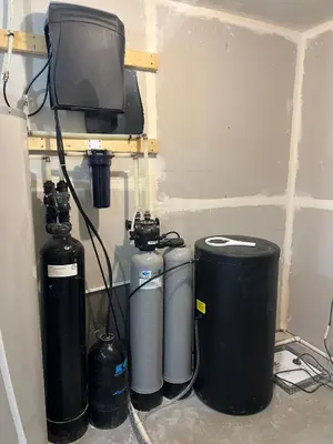 a group of three water tanks and a television in a room at Kizito in Edmonton