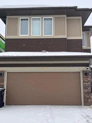 a house with a garage door in front of it at Kizito in Edmonton