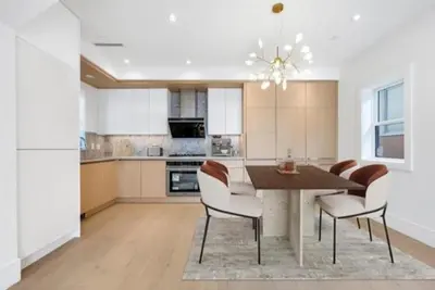 a kitchen with a dining room table and chairs at Luxury & brand-new Cozy duplex in South Vancouver in Vancouver