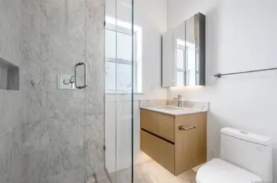 a bathroom with a shower and a toilet and a sink at Luxury & brand-new Cozy duplex in South Vancouver in Vancouver