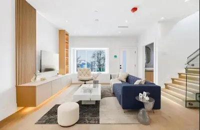 a living room with a blue couch and a table at Luxury & brand-new Cozy duplex in South Vancouver in Vancouver