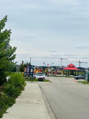a parking lot with a car parked on a street at West Edmonton- Rose in Edmonton