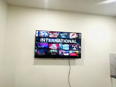 a flat screen tv hanging on a wall at West Edmonton- Rose in Edmonton