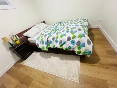 a bedroom with a bed with polka dot sheets at West Edmonton- Rose in Edmonton