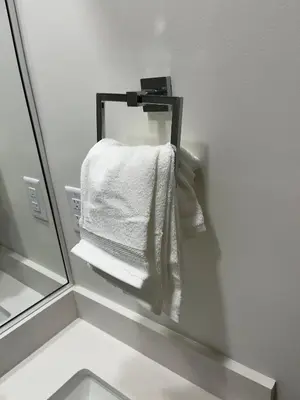 a bathroom with a mirror and white towels at cozy basement suite with 1-bed, wi-fi & Neflix in Edmonton