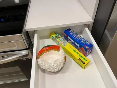 a white drawer with some food in a refrigerator at cozy basement suite with 1-bed, wi-fi & Neflix in Edmonton