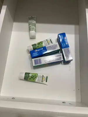 a shelf with toothbrushes and toothpaste in a refrigerator at cozy basement suite with 1-bed, wi-fi & Neflix in Edmonton