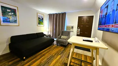 a living room with a couch and a table at Cloud 9 Inn in Whitecourt
