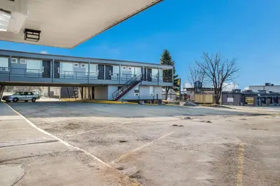 an empty parking lot in front of a building at Motel 6-Fort St. John, BC in Fort Saint John