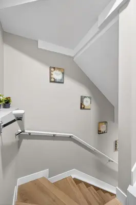a white staircase with two clocks on the wall at Guest Suite in Edmonton, King bed and parking in Edmonton