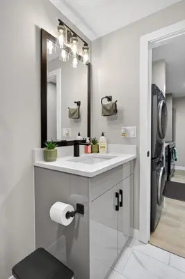 a white bathroom with a sink and a mirror at Guest Suite in Edmonton, King bed and parking in Edmonton