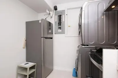 a kitchen with a stainless steel refrigerator and cabinets at Comfort Spacious 2-BR Suite in Arbutus in Vancouver