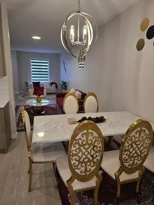 a dining room with a white table and chairs at Cozy Comfort Homestaed-Near Airport in Calgary