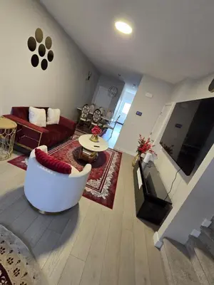 a large living room with a couch and a table at Cozy Comfort Homestaed-Near Airport in Calgary