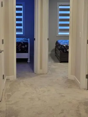a hallway with two beds in a room with blue walls at Cozy Comfort Homestaed-Near Airport in Calgary