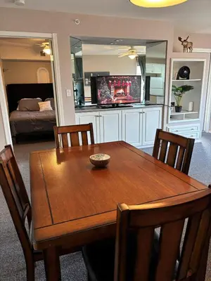 a dining room table with chairs and a television at Cozy getaway with a view! in Fairmont Hot Springs