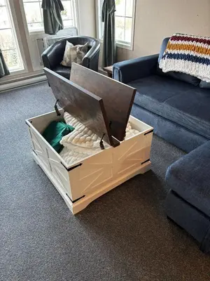 a box in the middle of a living room with a couch at Cozy getaway with a view! in Fairmont Hot Springs