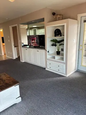 a living room with white cabinets and a potted plant at Cozy getaway with a view! in Fairmont Hot Springs