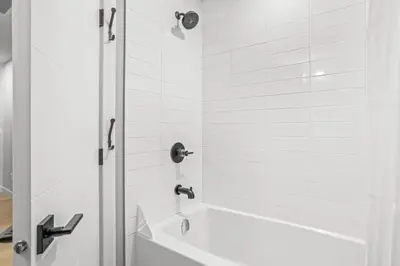 a bathroom with a shower with a white tub at Skyridge Mountain Retreat 4BR with BBQ Near Banff in Canmore
