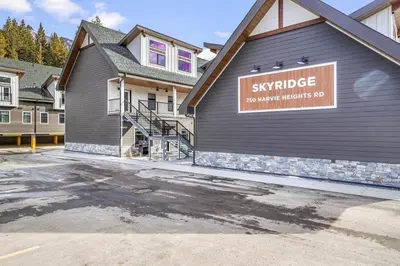 a building with a sign on the side of it at Skyridge Mountain Retreat 4BR with BBQ Near Banff in Canmore