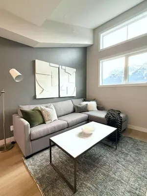a living room with a couch and a coffee table at Mountain Retreat with Views and Hot Tub Near Banff Gates in Canmore