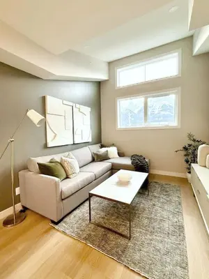 a living room with a couch and a table at Mountain Retreat with Views and Hot Tub Near Banff Gates in Canmore