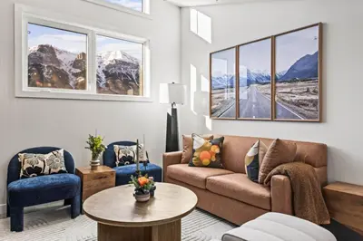 a living room with a couch and chairs and a table at Cozy 3BR Mountainside Haven Near Banff in Canmore