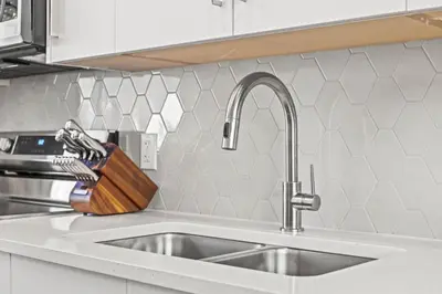 a kitchen counter with a sink and a knife holder at Cozy 3BR Mountainside Haven Near Banff in Canmore