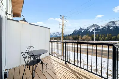 a balcony with a table and chairs and mountains at Scenic 3BR Townhouse with Mountain Views Near Banff in Canmore