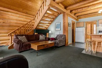 a living room with a couch and a table at Beautiful Cottage In The Heart Of The Rockies in Golden
