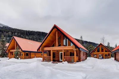 a log cabin with snow on the ground at Authentic, Timber Log Cabin Perfect for Groups in Golden