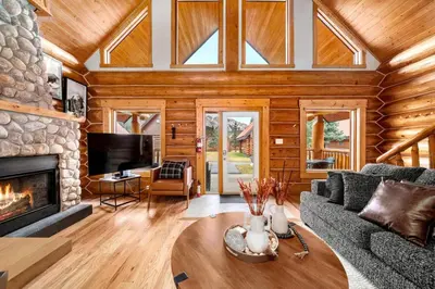 a living room with a couch and a fireplace at Rustic Cabin Hideaway with BBQ Fire Pit and Mtn Views in Golden