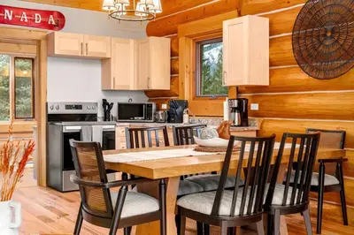 a kitchen and dining room with a table and chairs at Rustic Cabin Hideaway with BBQ Fire Pit and Mtn Views in Golden