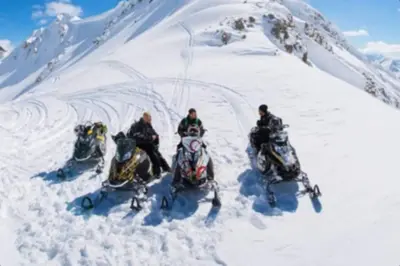 a group of four people on snow bikes in the snow at Rustic Chalet Perfect Getaway for Groups in Golden