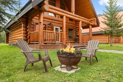 a fire pit in front of a log cabin at Rustic Chalet Perfect Getaway for Groups in Golden