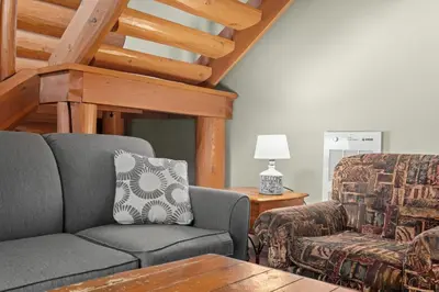 a living room with a couch and a chair at Rustic Chalet Perfect Getaway for Groups in Golden