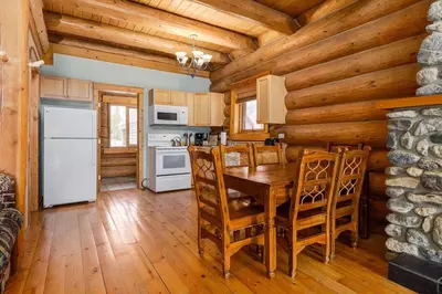 a kitchen with a table and chairs in a cabin at Wonderful Rockies Cabin Getaway for Hike or Ski in Golden