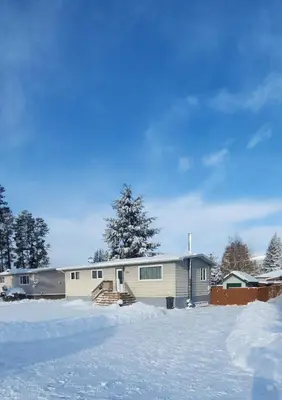 a house with snow in front of it at Mountain Joy Getaway in Valemount